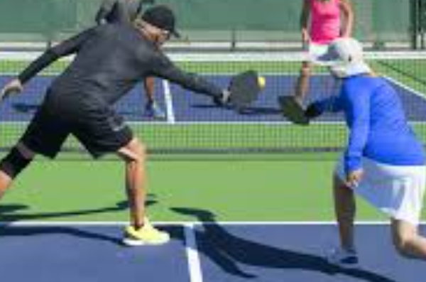 four people playing pickleball