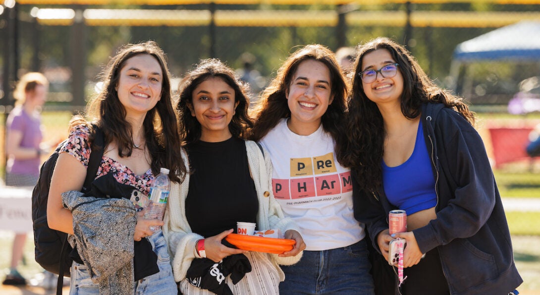 Four students posing with arms around each other at RecFest